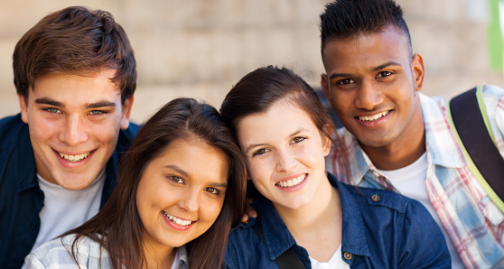 Close up of four Cestar High School students smiling